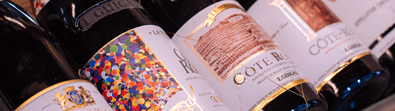 Two glasses of white wine toast the Auberge du Lyonnais cellar menu